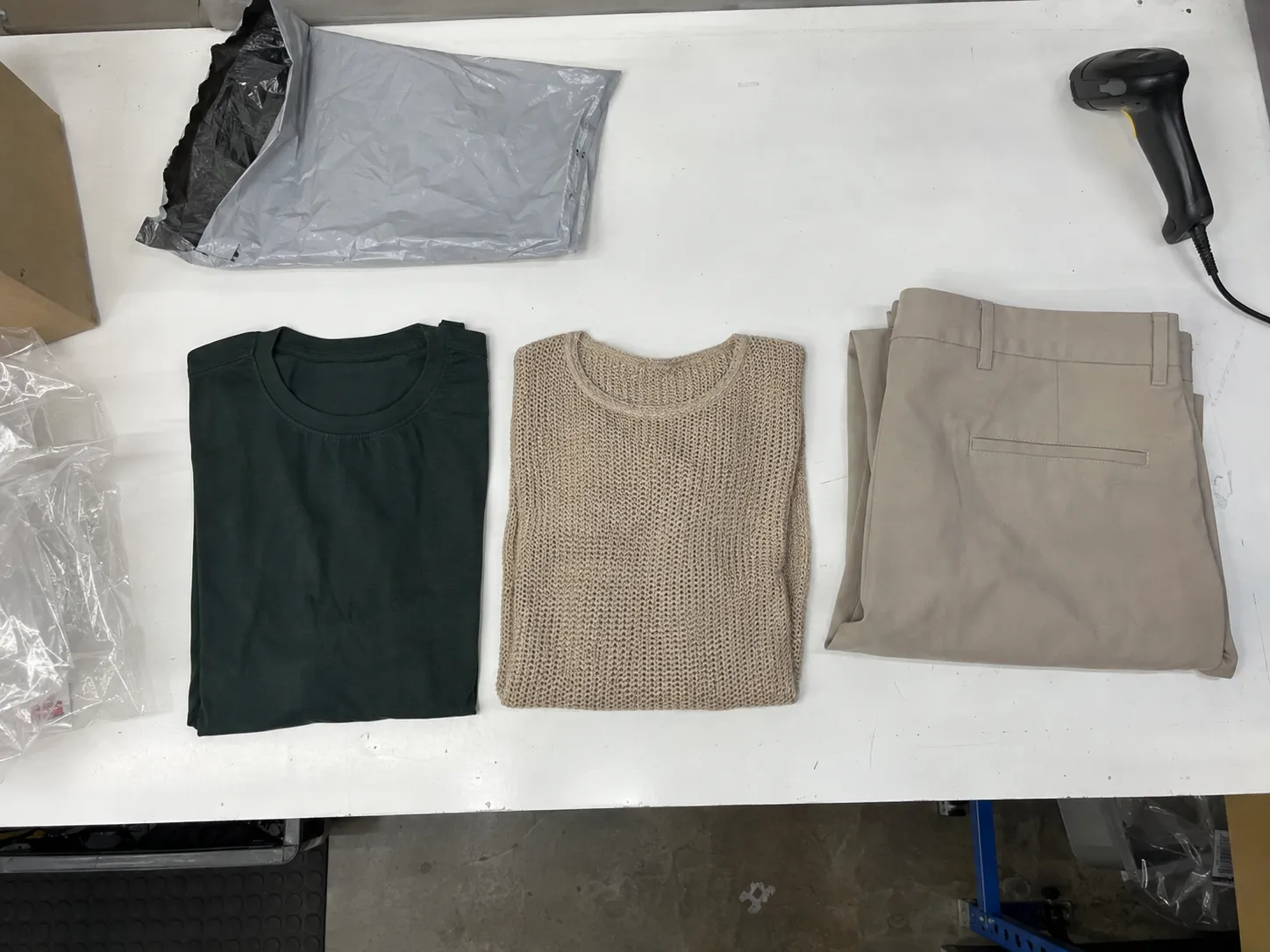 Overhead view of returned garments laid out on the bench